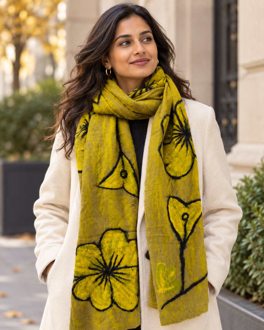 Woman wearing Feltiful hand-felted mustard yellow, taupe and black floral merino wool and silk scarf